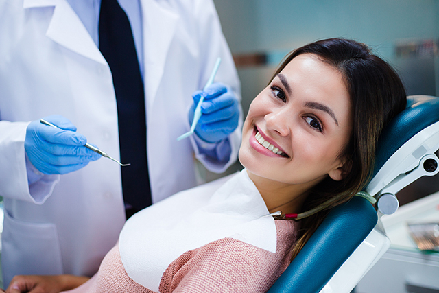 patient smiling after getting her treatment done by a dentist in modesto ca