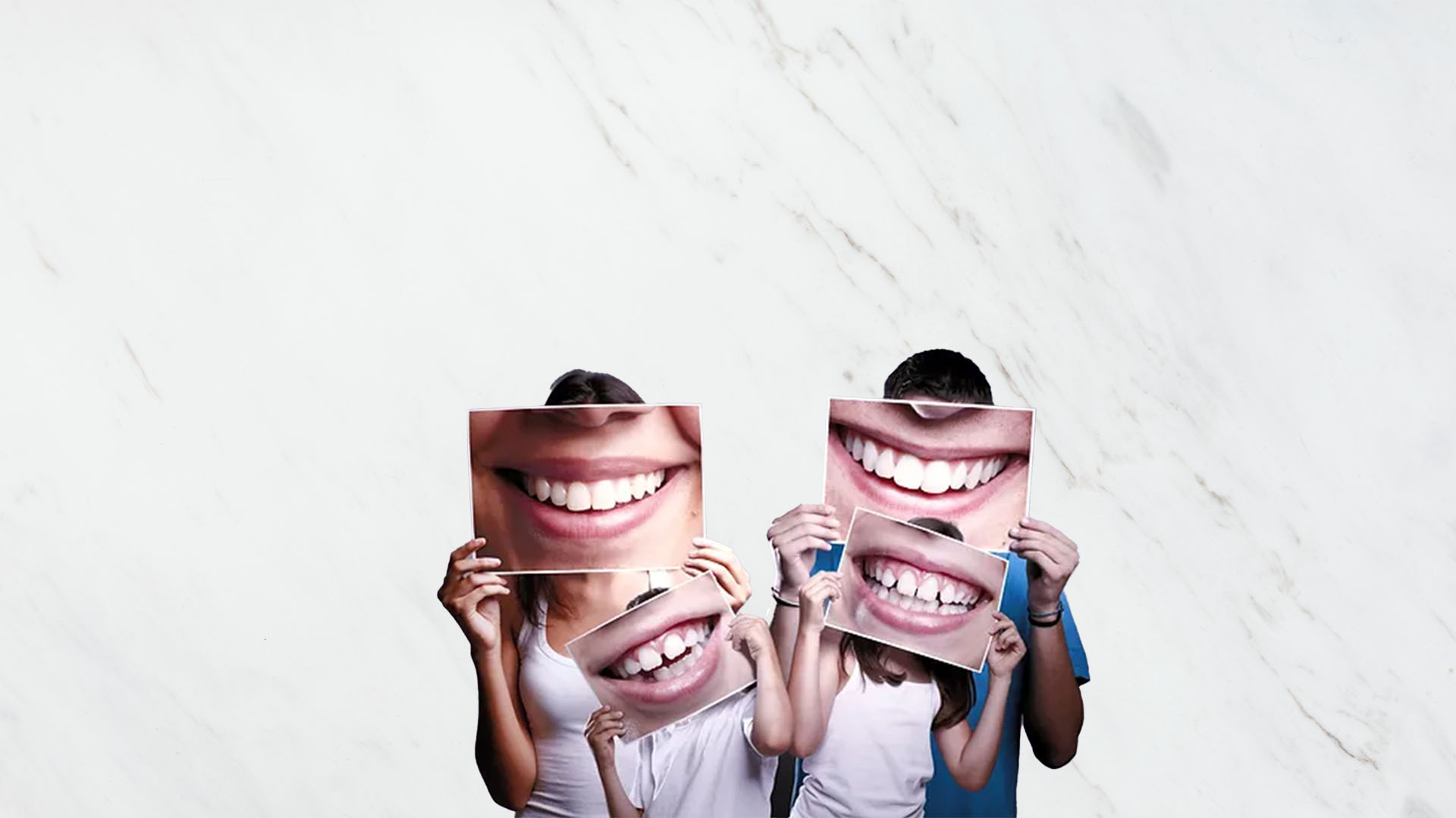 a family of four holding a picture of their smile zoomed in